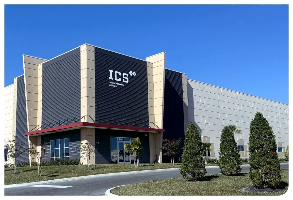 Commercial building exterior with ICS signage and landscaped frontage