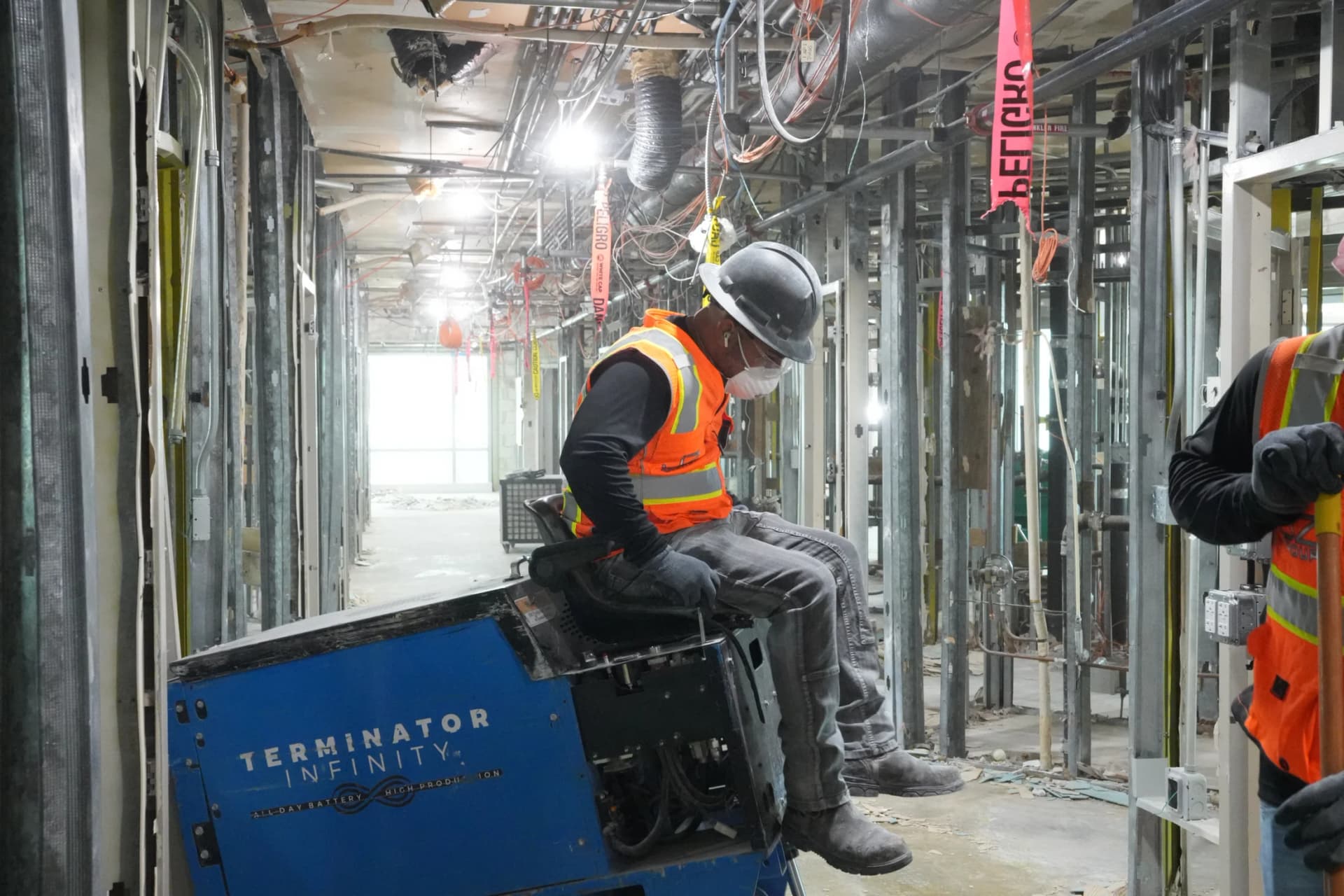 JZ operator at the controls of floor-removal equipment inside the UHealth Tower penthouse